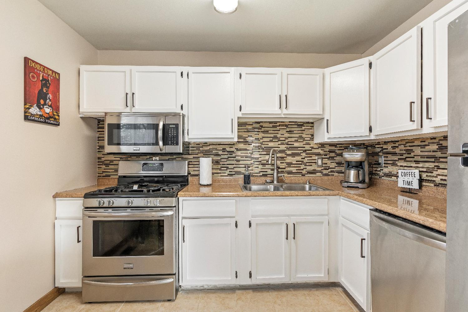 1412 North Elmer Street Griffith, IN 46319 - Photo 6 of 23 a kitchen with white cabinets and appliances