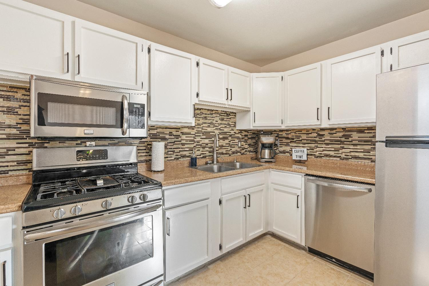 1412 North Elmer Street Griffith, IN 46319 - Photo 7 of 23 a kitchen with cabinets appliances and a sink