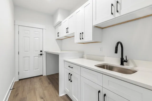 a kitchen with sink a faucet and cabinets