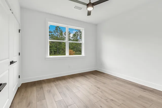 wooden floor in an empty room with a window
