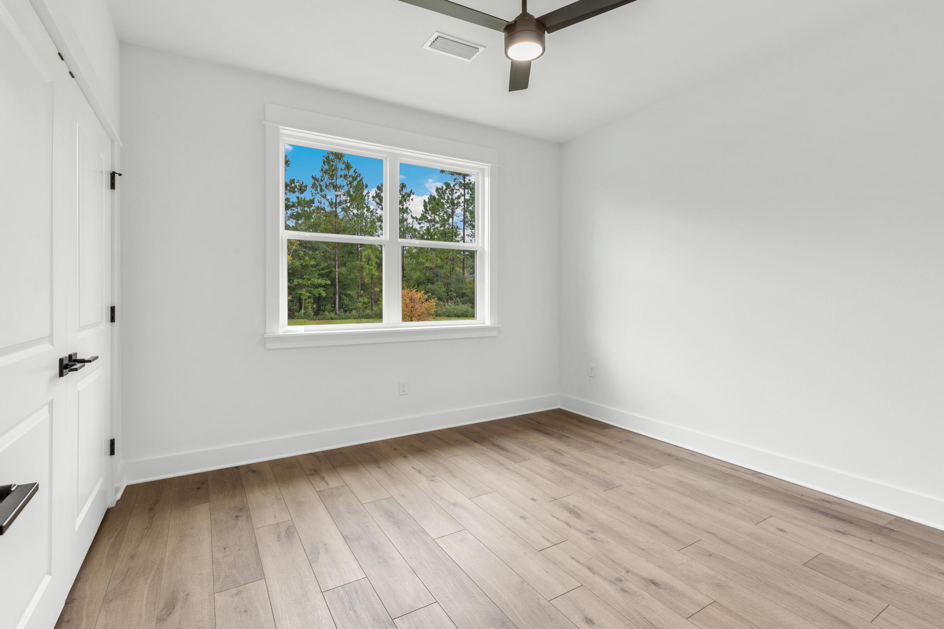 80 Clarke Hl Road Freeport, FL 32439 - Photo 16 of 33 wooden floor in an empty room with a window