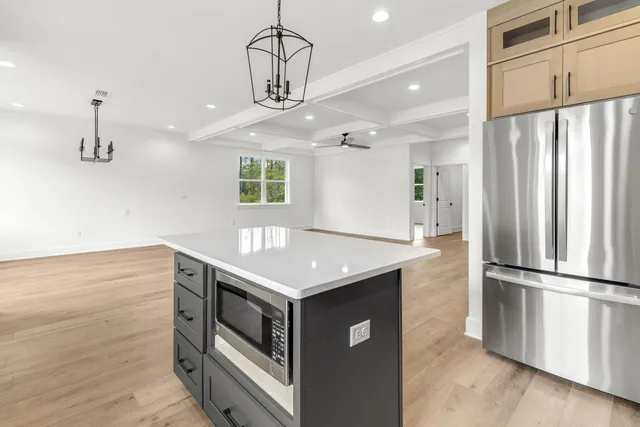 a kitchen with stainless steel appliances granite countertop a refrigerator a stove and a refrigerator