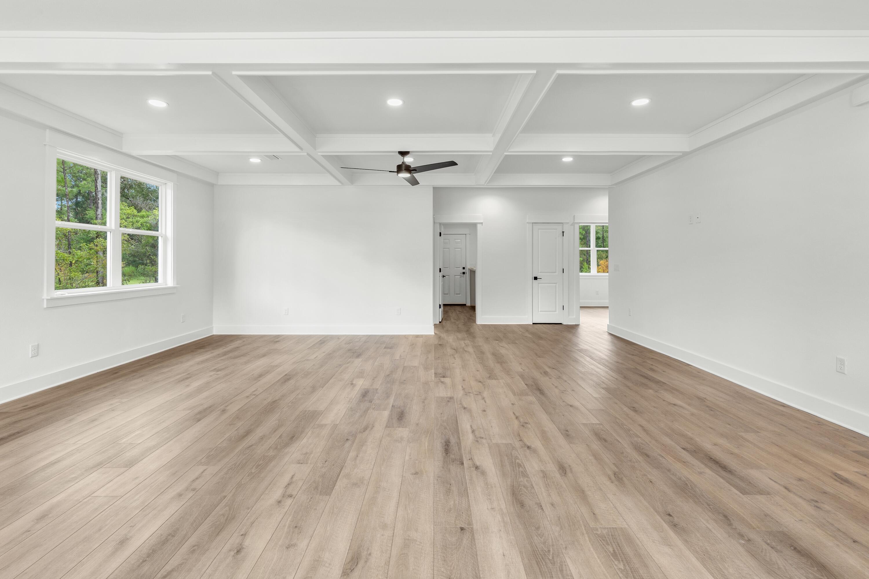 80 Clarke Hl Road Freeport, FL 32439 - Photo 9 of 33 an empty room with wooden floor and windows