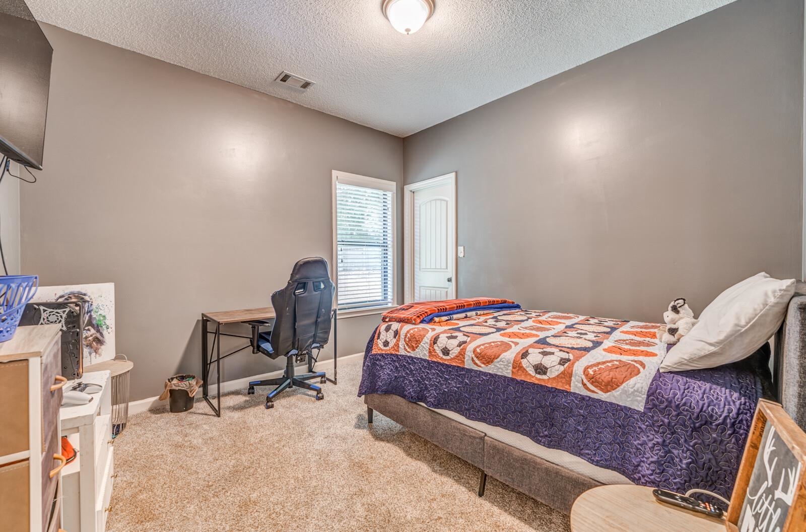 4671 Hampton Ridge Lane Bartlett, TN 38002 - Photo 29 of 40 Carpeted bedroom with a single window, a flush-mount ceiling light, and a paneled door
