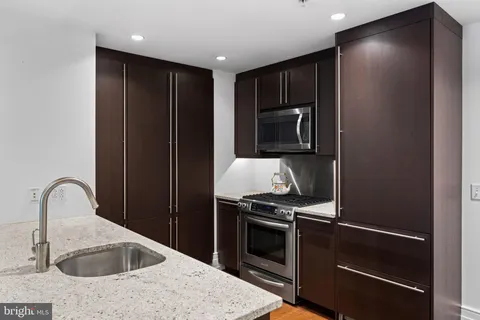 a kitchen with a refrigerator and a sink