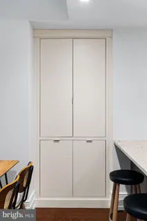 a view of a room with furniture and wooden floor