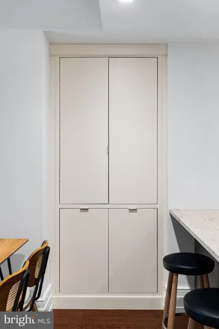 a view of a room with furniture and wooden floor