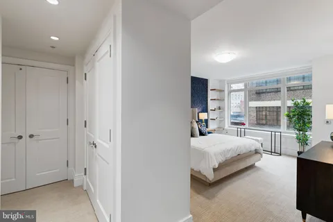 a bedroom with bed and a potted plant