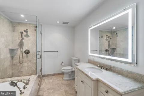 a bathroom with a tub and toilet