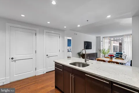 a kitchen with sink cabinets and living room