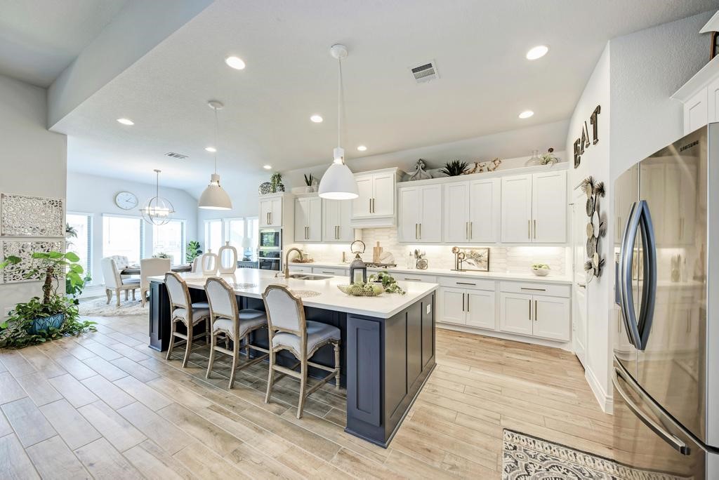 a kitchen with appliances a sink a counter top space and cabinets