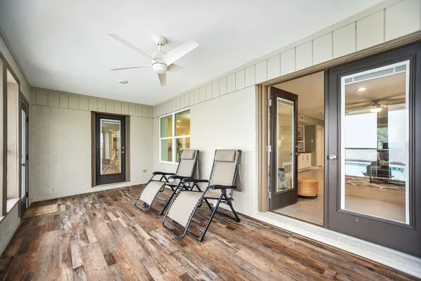 a workspace with wooden floor and windows
