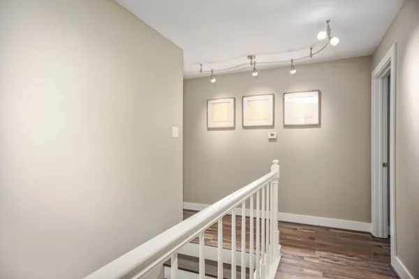 a view of entryway and hall with wooden floor