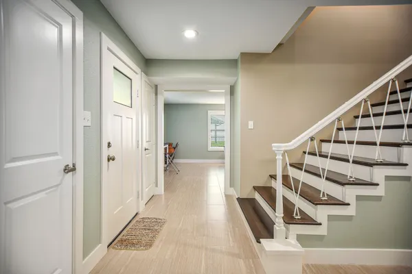 a view of an entryway with wooden floor