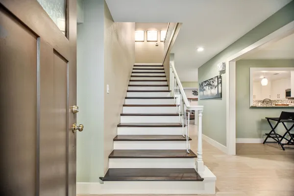 a view of entryway and hall with wooden floor