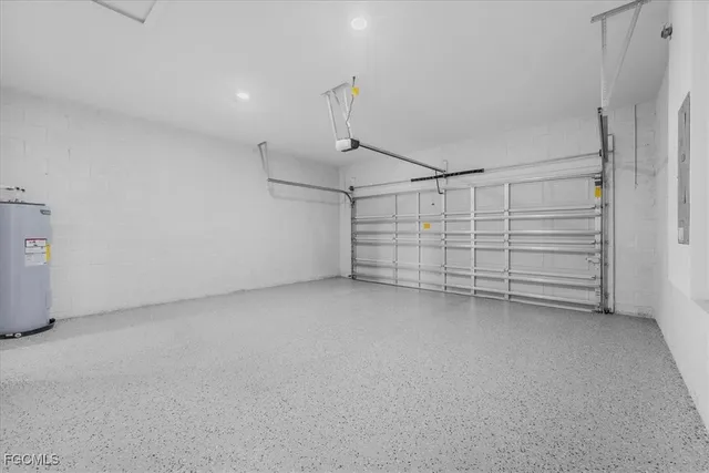 a view of a kitchen with refrigerator and wooden floor