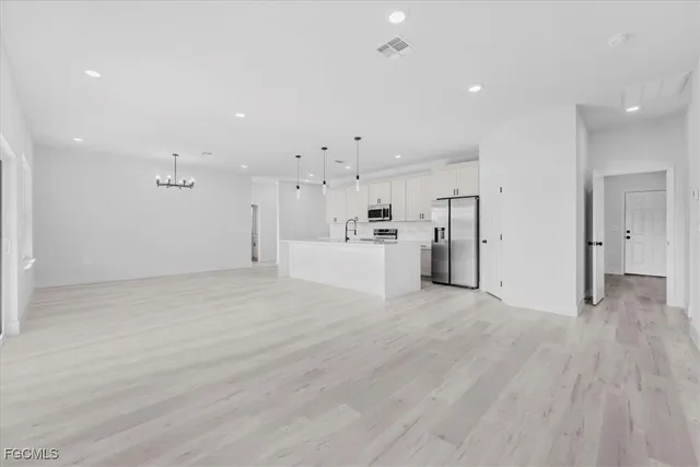 a view of a kitchen with a refrigerator and a sink