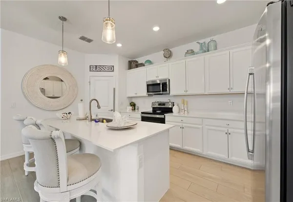 a kitchen with stainless steel appliances granite countertop a sink a stove and a refrigerator