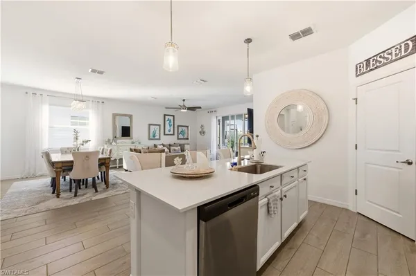 a kitchen with sink cabinets and dining table