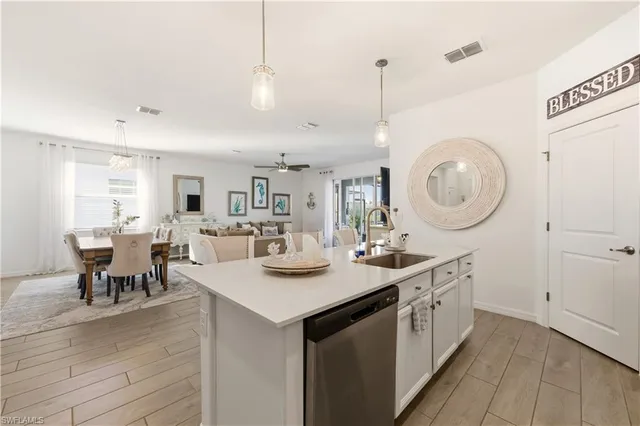 a kitchen with sink cabinets and dining table