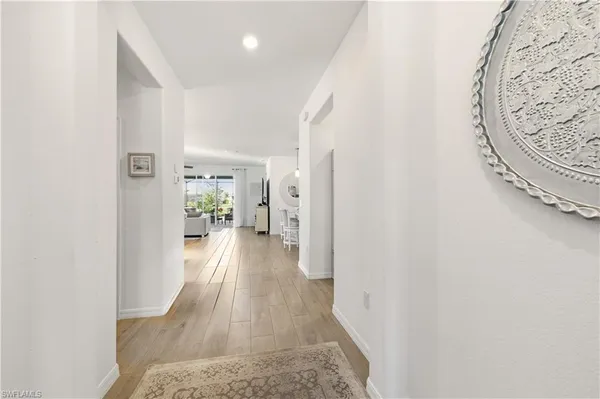 a view of a hallway with wooden floor