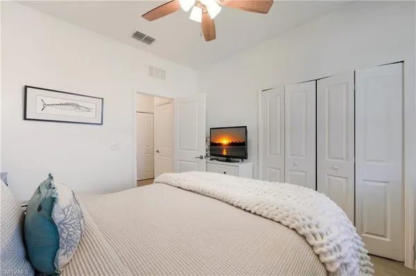 a bedroom with a bed and a television