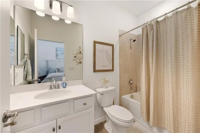 a bathroom with a sink a toilet a mirror a vanity and shower