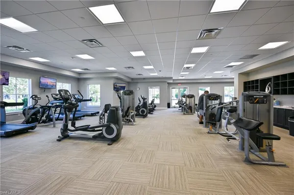 a view of a room with gym equipment and a large window