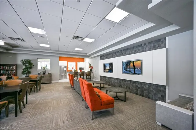 a living room with furniture kitchen view and a large window