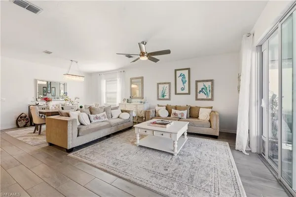 a living room with furniture or couch and a ceiling fan