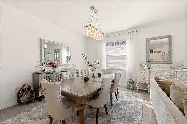 a view of a dining room with furniture and a chandelier