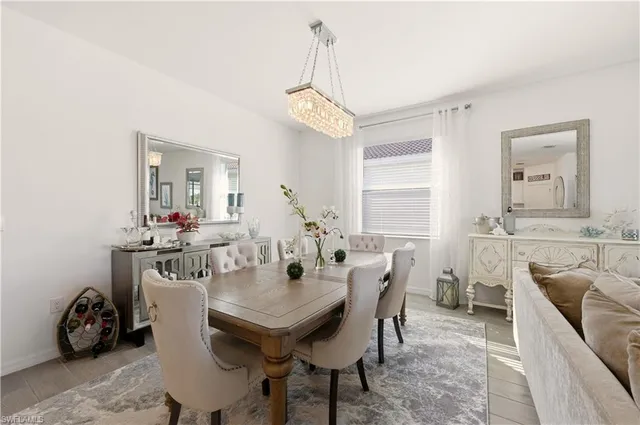 a view of a dining room with furniture and a chandelier