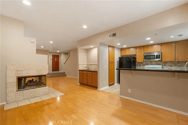 a kitchen with a sink stove top oven and cabinets