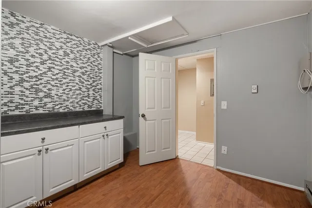 a view of a kitchen with wooden floor and a sink