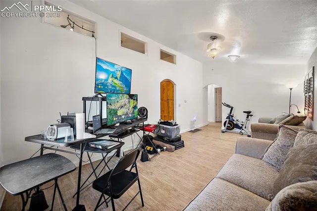 a living room with furniture kitchen view and a large window