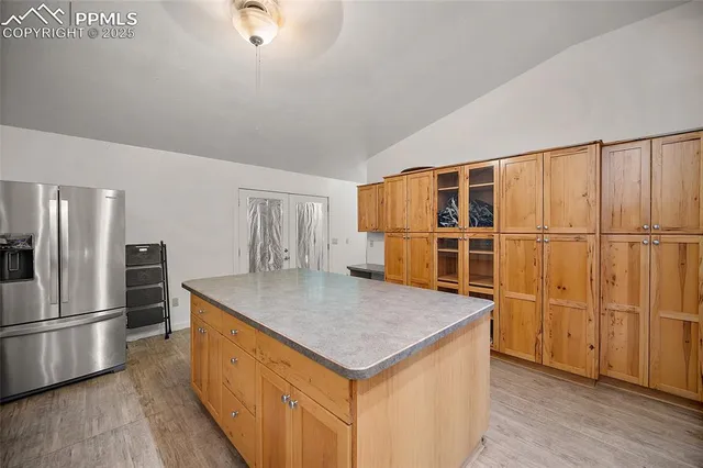 a kitchen with stainless steel appliances granite countertop a refrigerator a sink and a stove