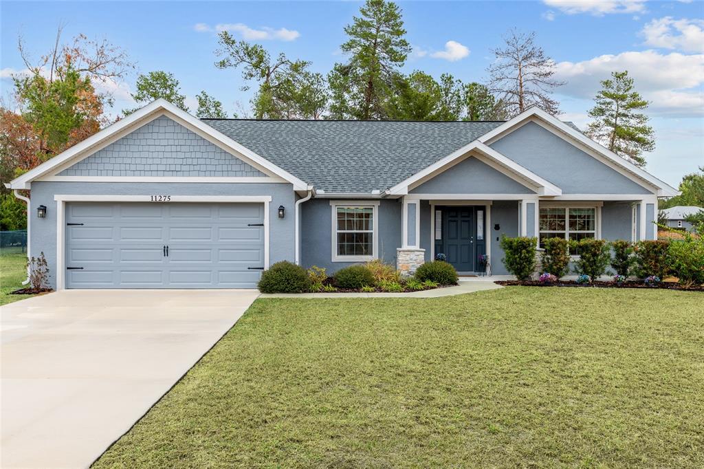 11275 Southwest 54th Circle Ocala, FL 34476 - Photo 1 of 1 a front view of a house with yard and green space