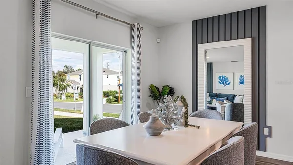 a dining room with furniture and wooden floor