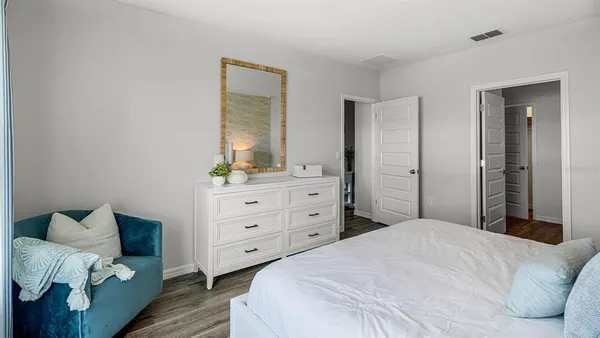 a bedroom with a bed and a dresser