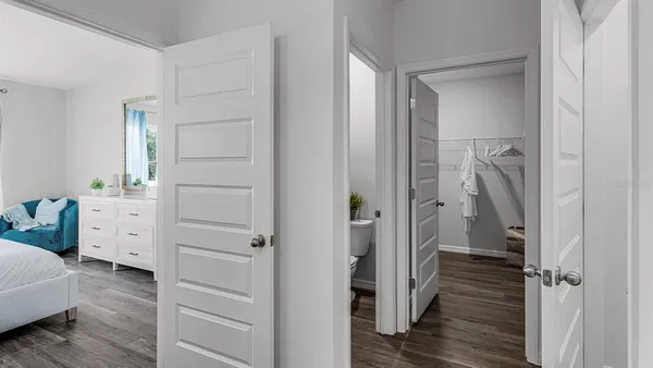 a view of closet with wooden floor