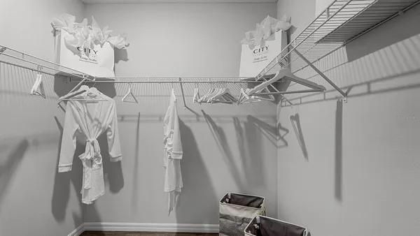 a bedroom with a large bed and a potted plant