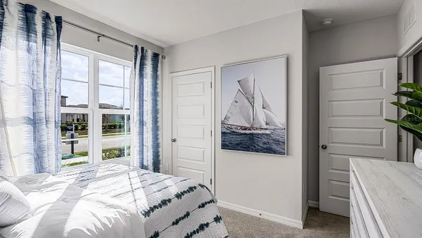 a bedroom with a bed and a mirror