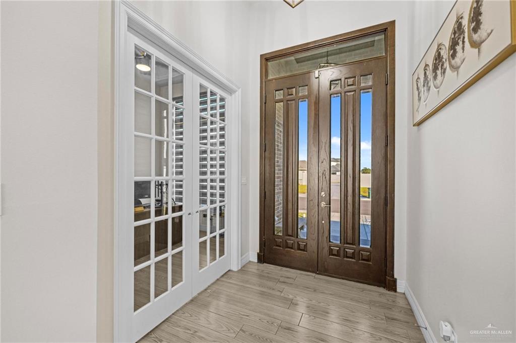 1110 Raptor Street Palmview, TX 78572 - Photo 9 of 31 Doorway to outside featuring wood finished floors and french doors