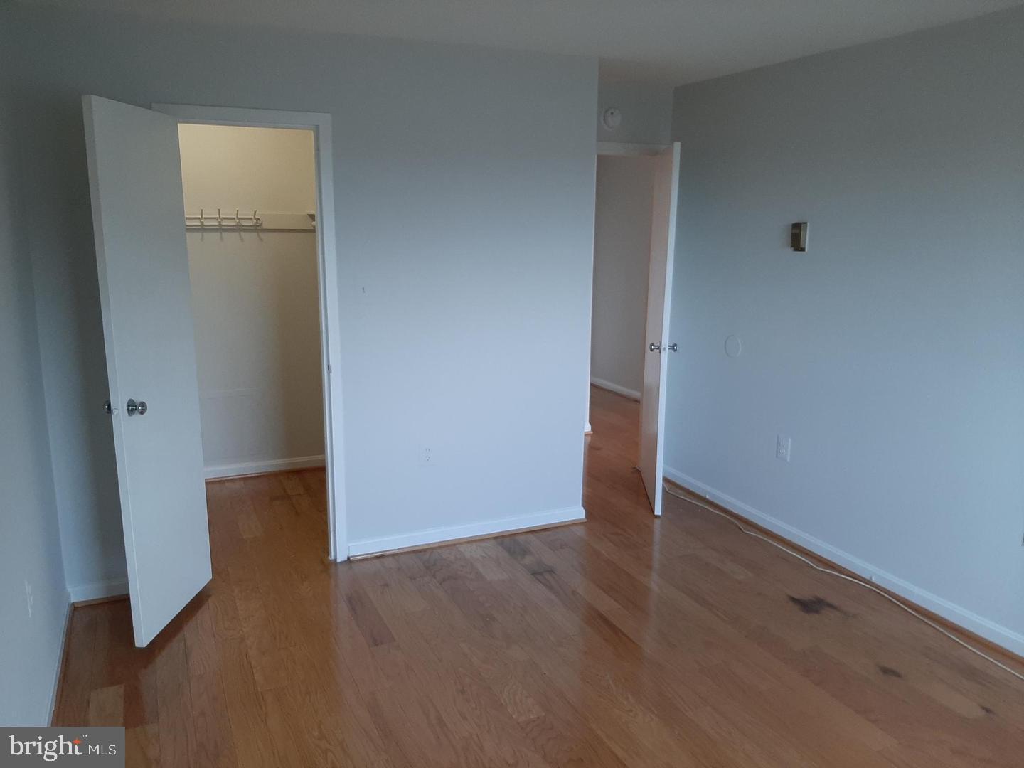2500 North Van Dorn Street, Unit 419 Alexandria, VA 22302 - Photo 16 of 20 an empty room with wooden floor and closet