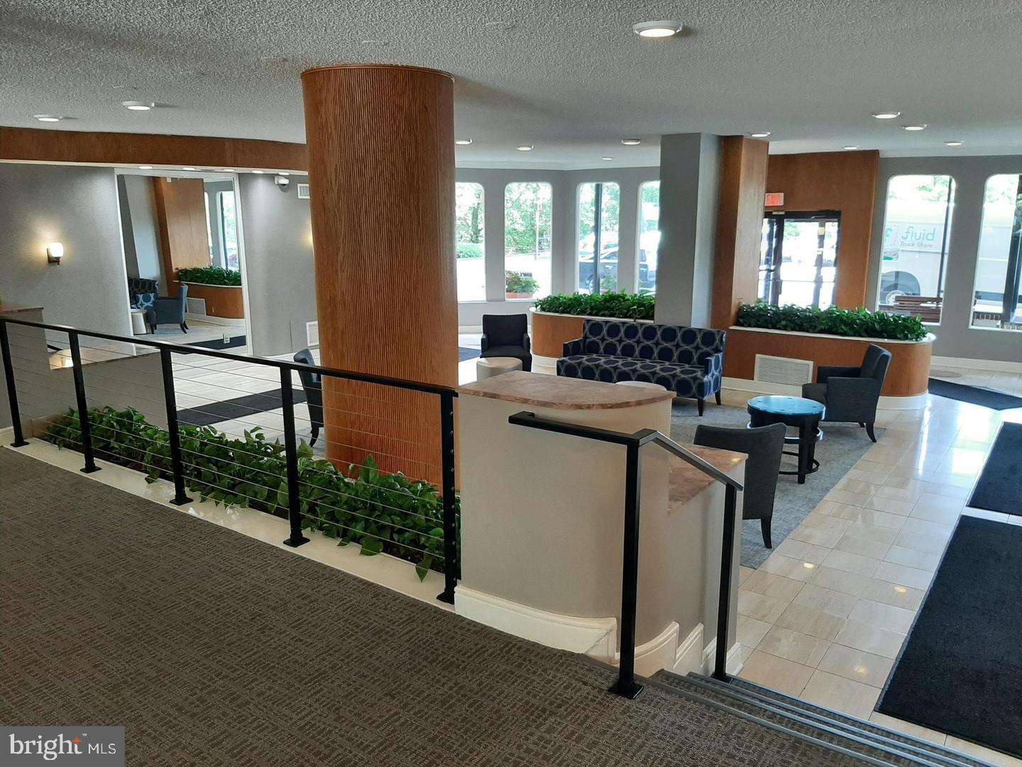 2500 North Van Dorn Street, Unit 419 Alexandria, VA 22302 - Photo 4 of 20 a lobby with furniture and floor to ceiling window