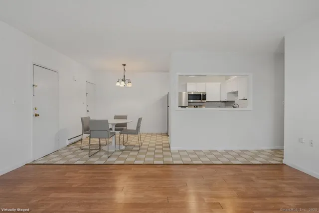 a kitchen with granite countertop a sink cabinets and wooden floor