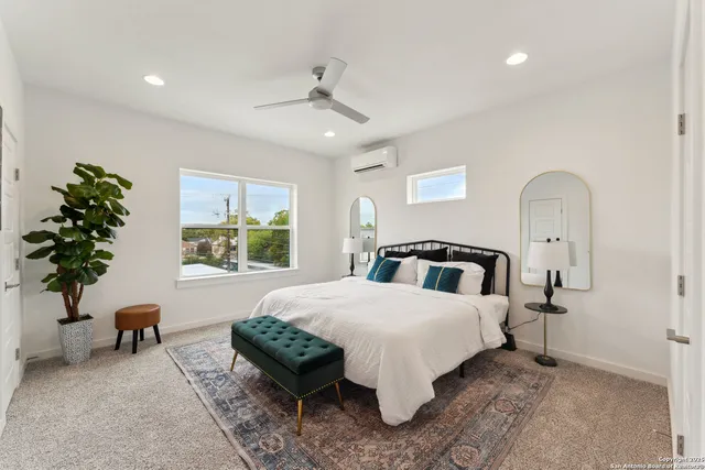 a spacious bedroom with a bed and a chandelier