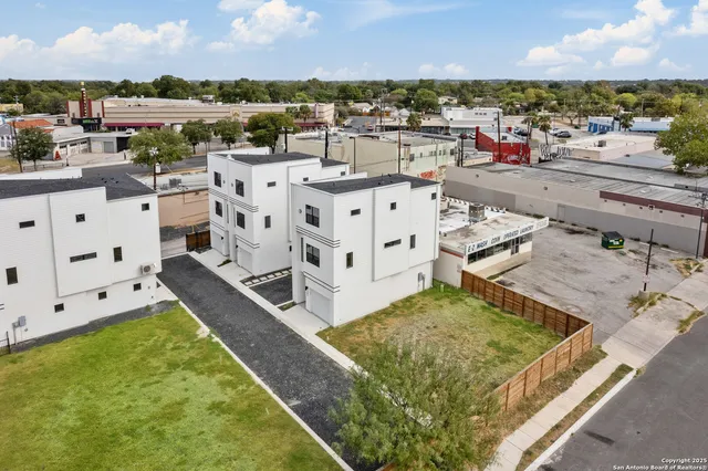 a view of a white building in the middle of a city