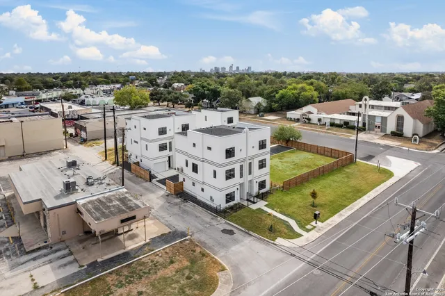 a view of a terrace with lawn chairs