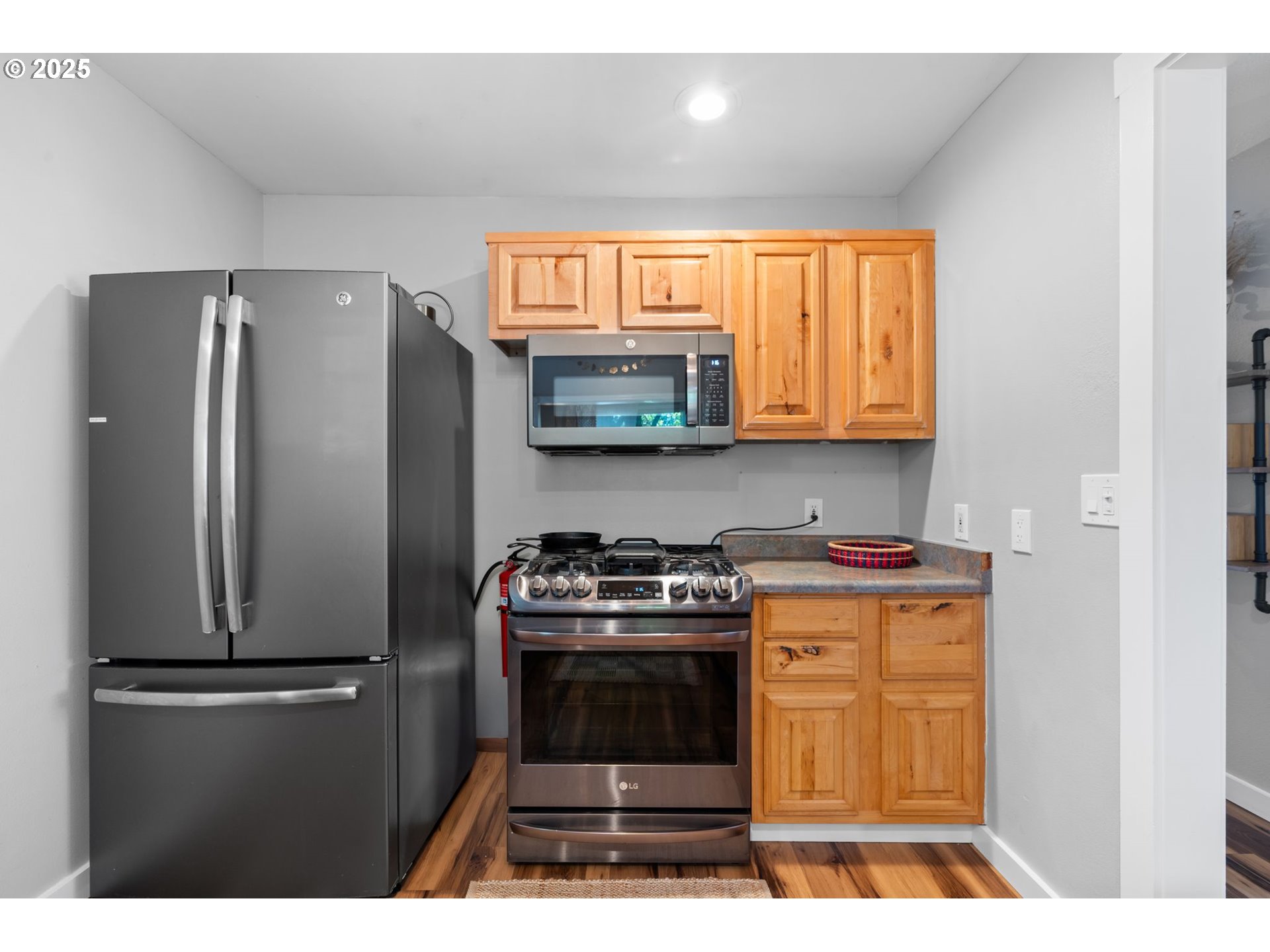 4517 Northeast 85th Avenue Portland, OR 97220 - Photo 13 of 38 a kitchen with stainless steel appliances granite countertop a refrigerator a stove a sink and a microwave